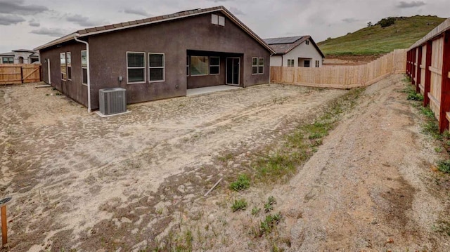 back of house featuring central AC unit