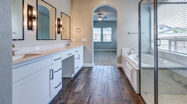 bathroom featuring vanity, wood-type flooring, ceiling fan, and separate shower and tub