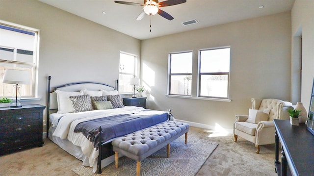 bedroom with ceiling fan and light carpet