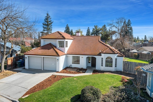 mediterranean / spanish-style home featuring a front lawn and a garage