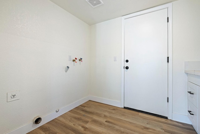 laundry room featuring hookup for a washing machine, light wood-type flooring, hookup for an electric dryer, and gas dryer hookup