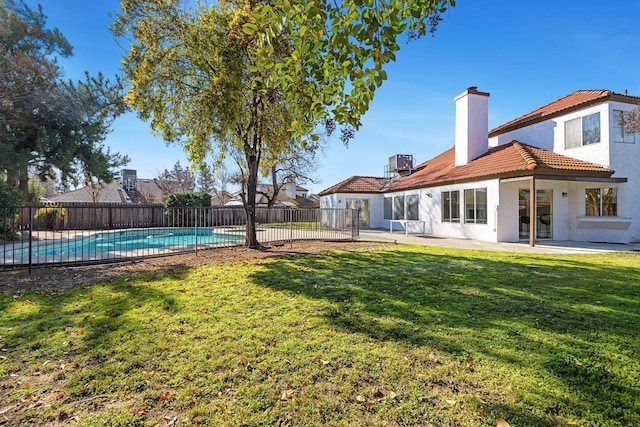 view of yard featuring a patio, a fenced in pool, and cooling unit