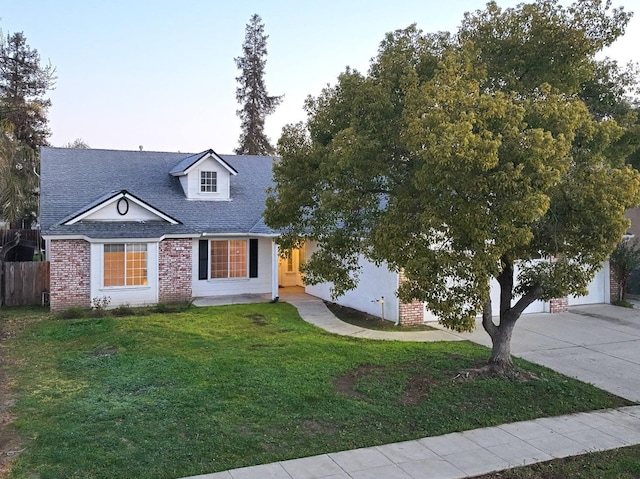 view of front of property with a garage and a front lawn