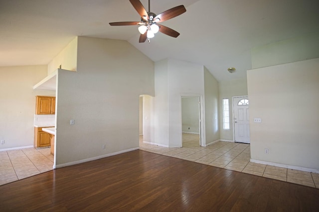 unfurnished living room featuring ceiling fan, high vaulted ceiling, and light hardwood / wood-style flooring