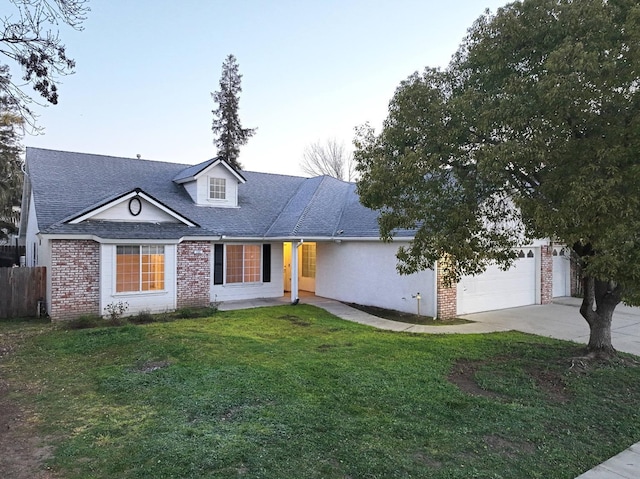 view of front of house with a garage and a front lawn