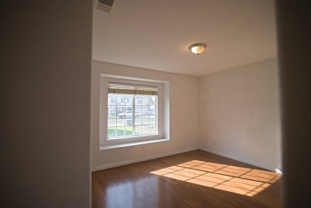 spare room featuring dark hardwood / wood-style flooring