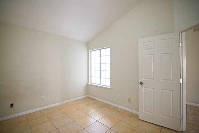 tiled spare room with high vaulted ceiling