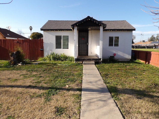 bungalow-style house with a front yard