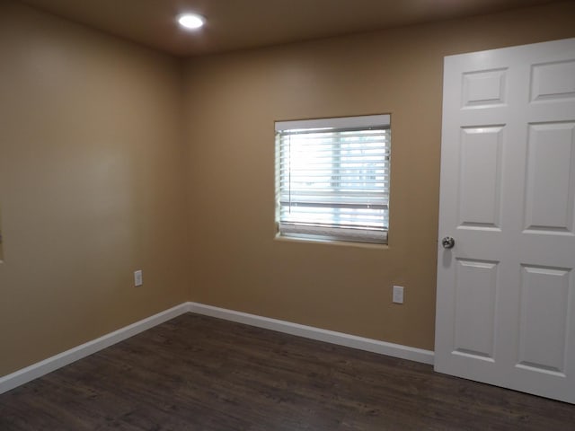 empty room with dark hardwood / wood-style floors