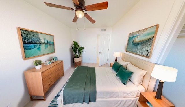 bedroom with ceiling fan, vaulted ceiling, and visible vents