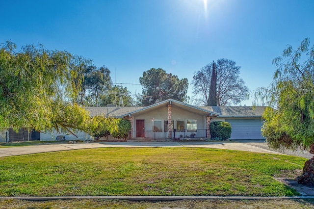 ranch-style house featuring a garage, covered porch, and a front lawn