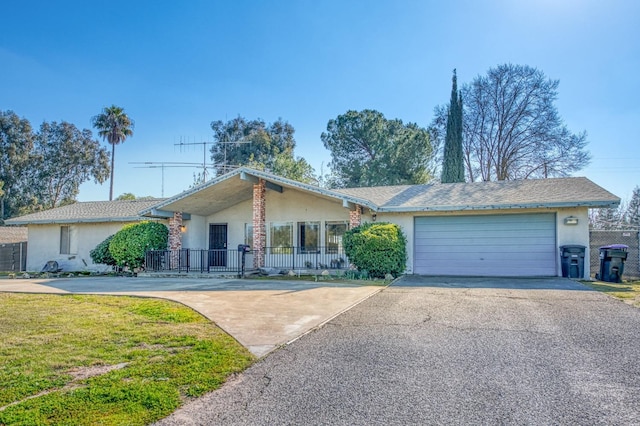 ranch-style home featuring a garage and a front yard