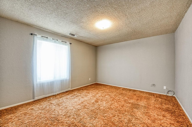 carpeted spare room featuring a textured ceiling