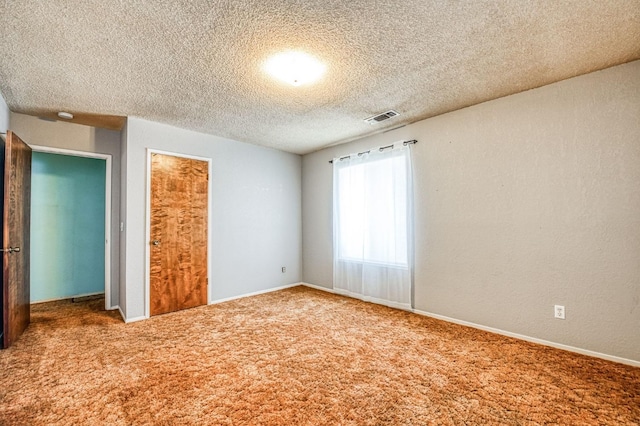 unfurnished bedroom featuring a closet, carpet, and a textured ceiling