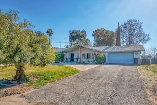 single story home featuring a garage and a front yard