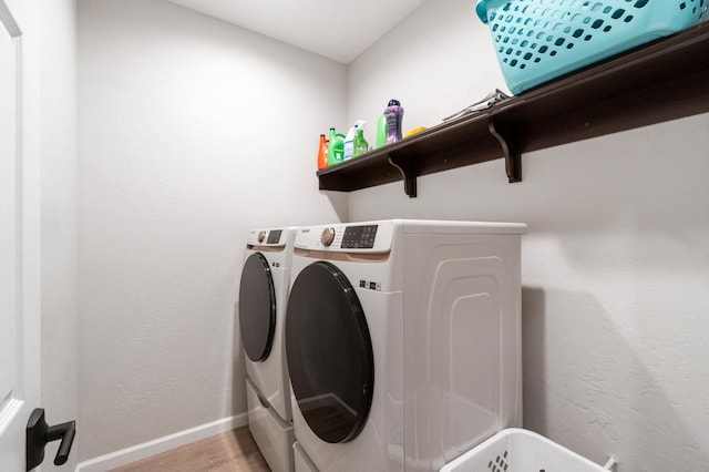 laundry area featuring separate washer and dryer and light wood-type flooring