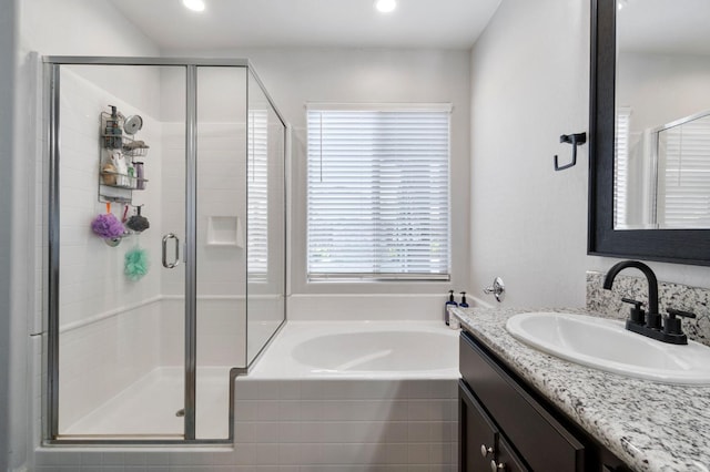 bathroom with vanity and independent shower and bath