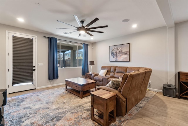 living room featuring ceiling fan and light wood-type flooring