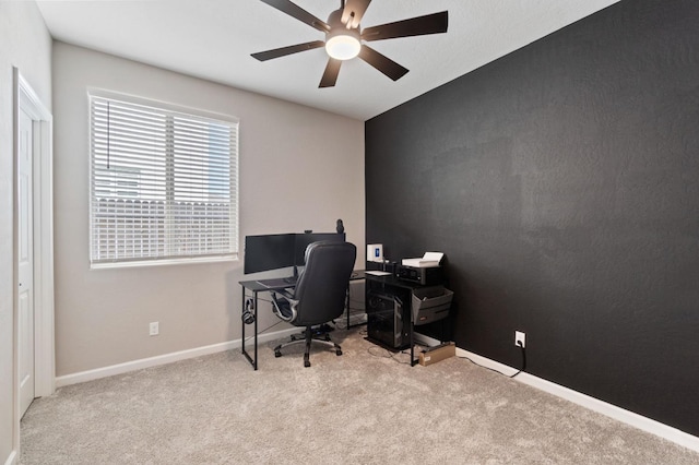 carpeted home office featuring ceiling fan