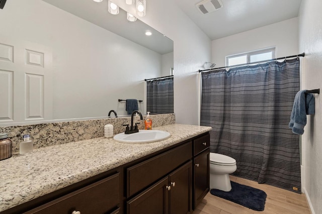 bathroom with hardwood / wood-style flooring, vanity, toilet, and a shower with shower curtain