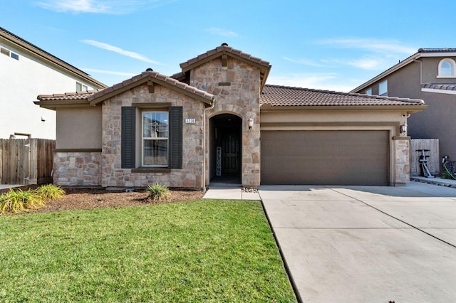 mediterranean / spanish home featuring a garage and a front lawn