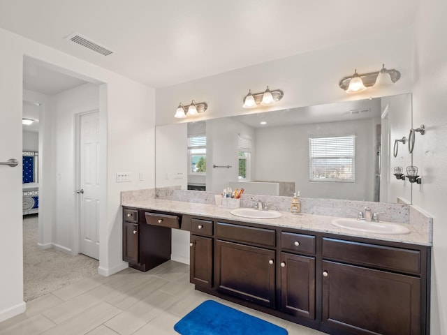 bathroom with vanity and a healthy amount of sunlight