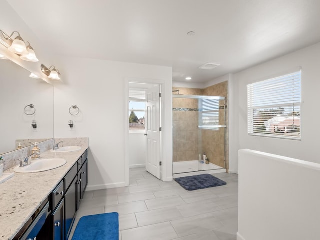 bathroom with vanity and a shower with door