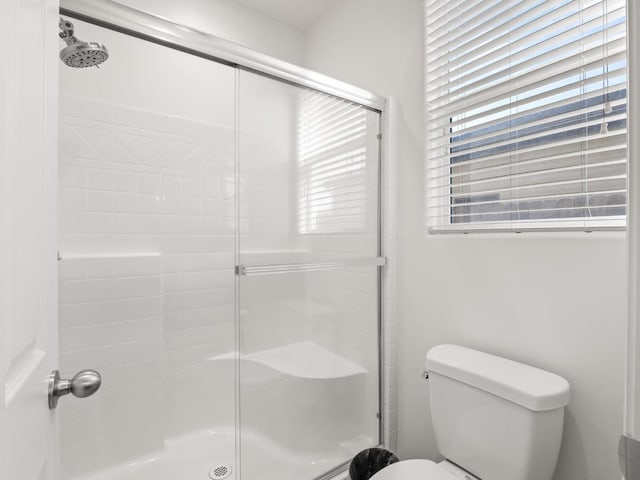 bathroom with toilet and walk in shower