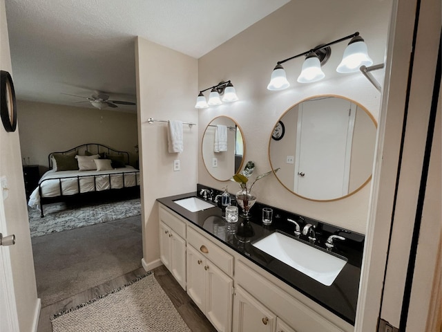 42959 Ranger Circle Ct, Coarsegold, CA 93614 - ensuite bathroom with a ceiling fan, double vanity, and baseboards
