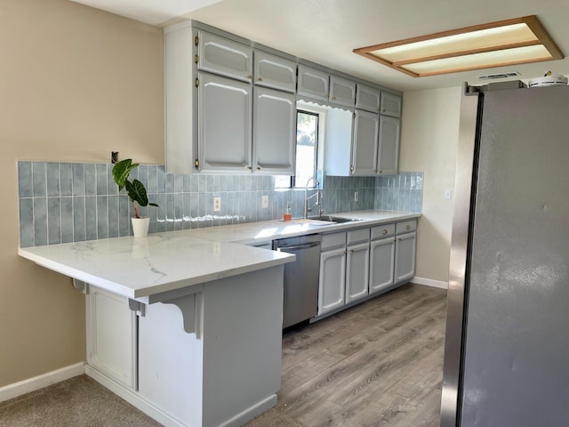 42959 Ranger Circle Ct, Coarsegold, CA 93614 - kitchen with freestanding refrigerator, a peninsula, dishwasher, tasteful backsplash, and a sink