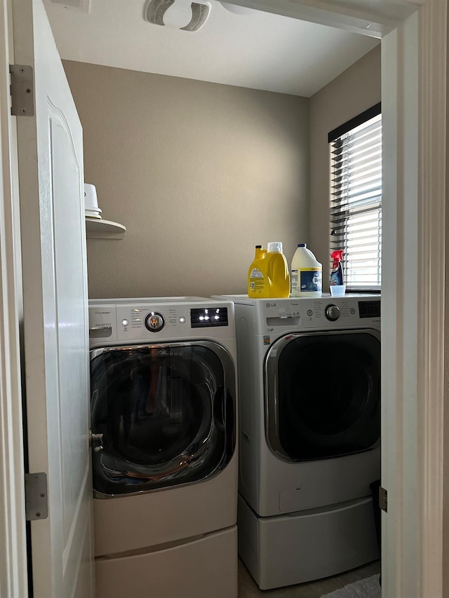 washroom featuring washing machine and dryer