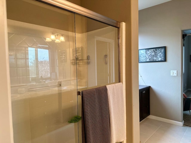 bathroom with tile patterned floors and a shower with door