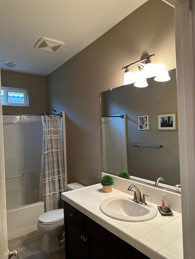 full bathroom featuring vanity, shower / tub combo with curtain, tile patterned floors, and toilet