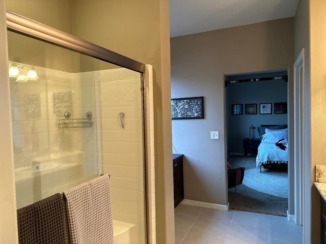 bathroom featuring tile patterned flooring, vanity, and walk in shower