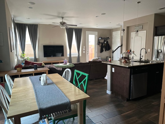 dining space with sink, a healthy amount of sunlight, and ceiling fan