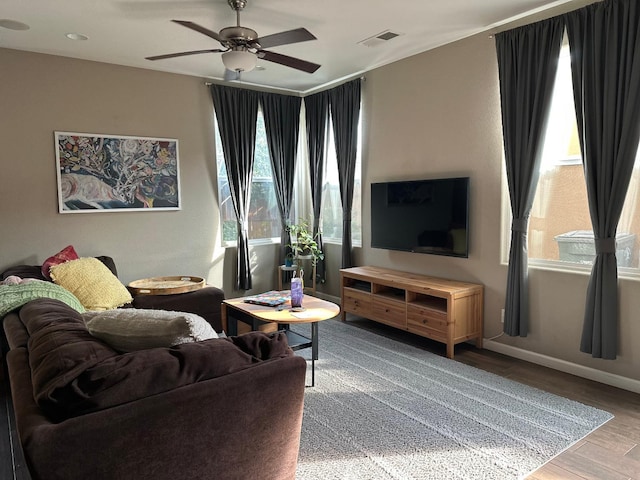 living room featuring ceiling fan and wood-type flooring