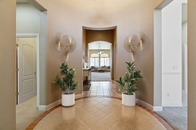 hall featuring light tile patterned floors