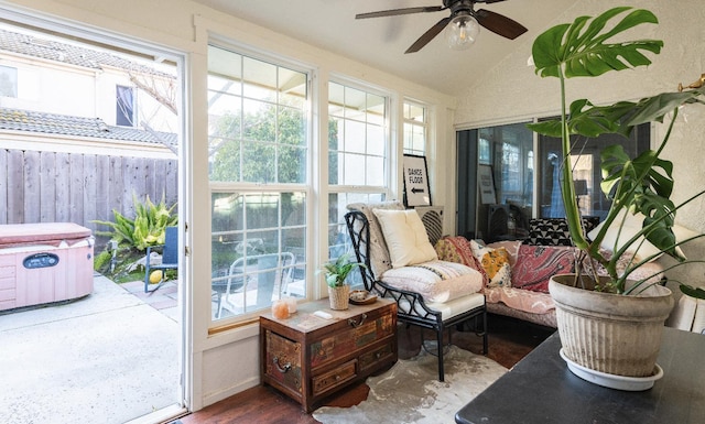 sunroom / solarium with ceiling fan and lofted ceiling