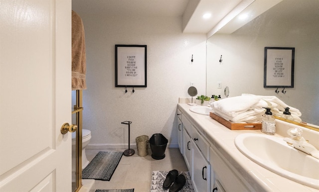 bathroom featuring vanity, toilet, and tile patterned flooring