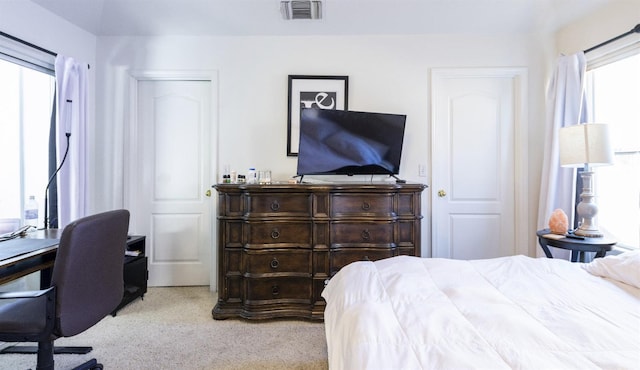 bedroom with light colored carpet