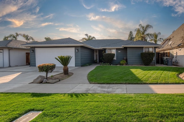 ranch-style house featuring a garage and a front lawn