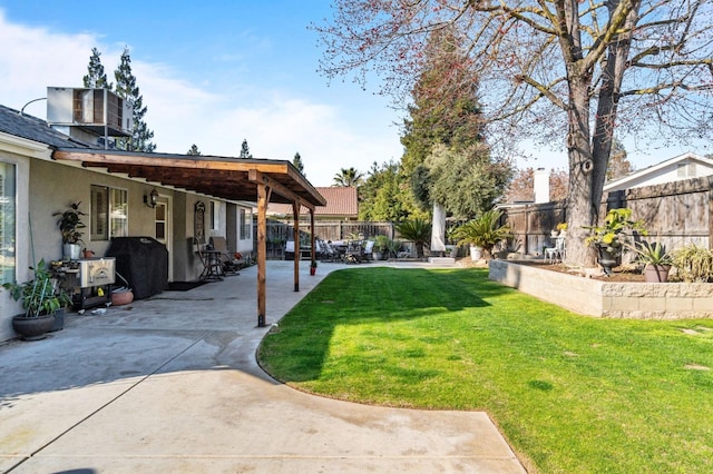 view of yard featuring a patio, central AC unit, and a fenced backyard