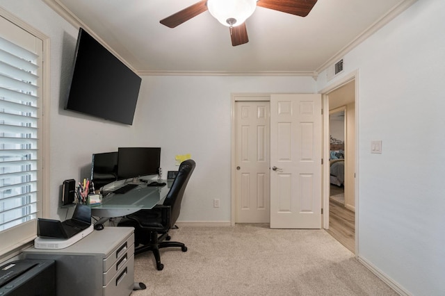 carpeted office space with ceiling fan and ornamental molding