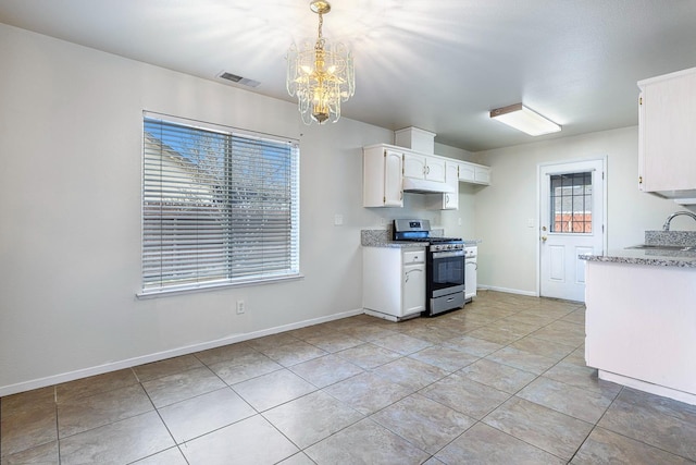 kitchen featuring stainless steel gas range, sink, white cabinetry, an inviting chandelier, and hanging light fixtures