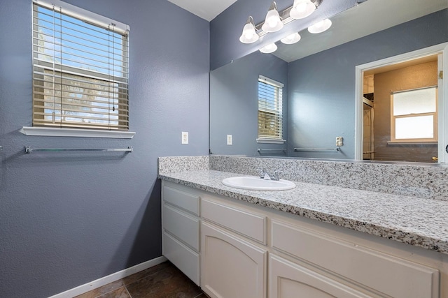 bathroom featuring walk in shower and vanity