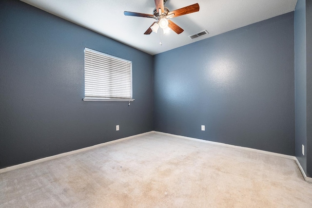 spare room featuring ceiling fan and light carpet