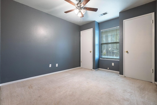 empty room with light colored carpet and ceiling fan