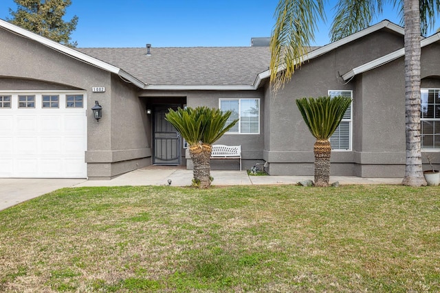 view of front facade with a garage and a front lawn