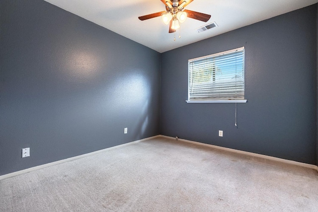 carpeted spare room featuring ceiling fan