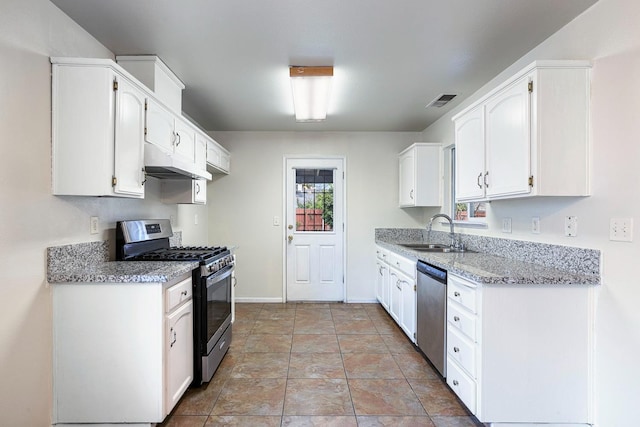 kitchen with white cabinetry, sink, stainless steel appliances, and light stone countertops